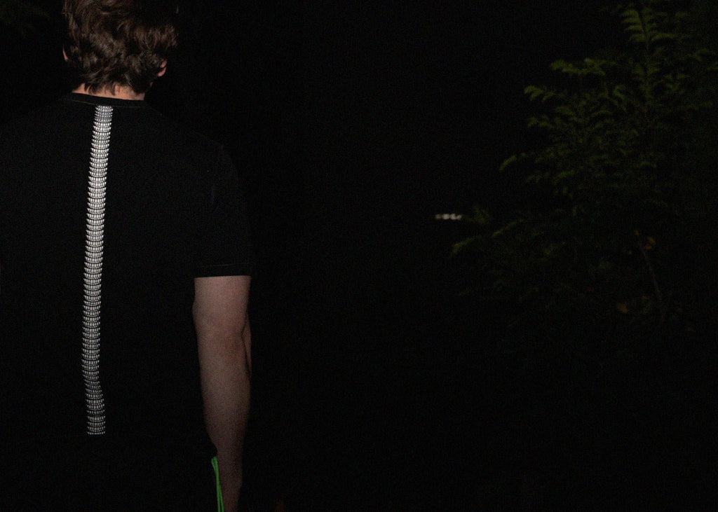 man facing away from camera wearing normal;c movement backbone internal hanging thread t-shirt