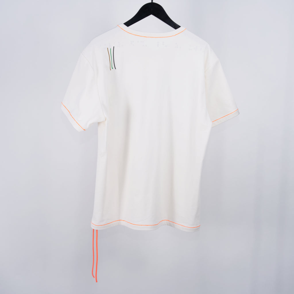 normal;c movement Blind Value Internal Hanging Thread T-Shirt, shown from the back, with small colorful graphics on the left-hand shoulder, on a white background and hanging on black hanger.