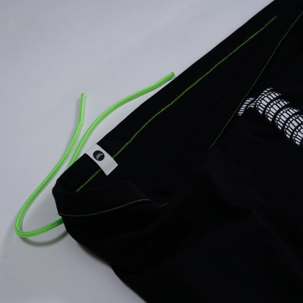 Black t-shirt with bright green strings on a light gray background.