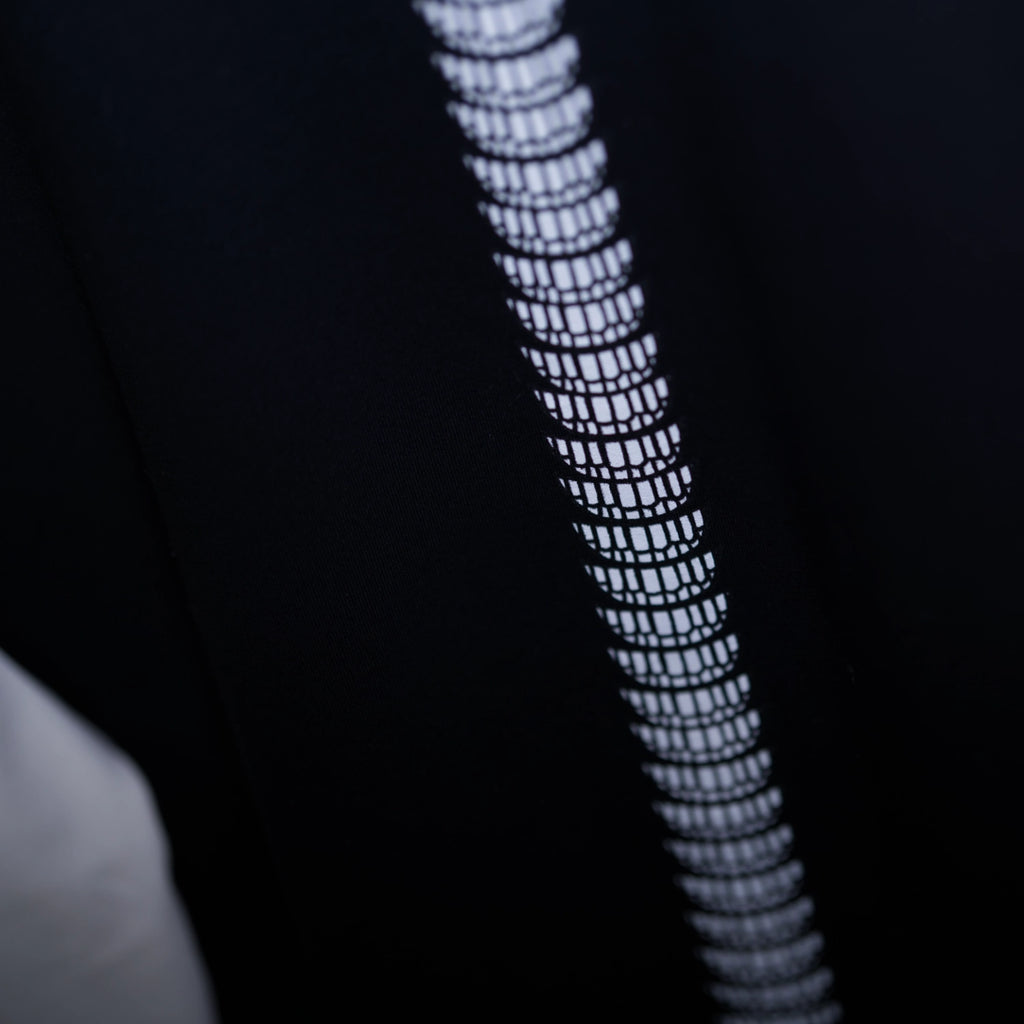 Close-up of a textured black and white smile pattern on a dark background